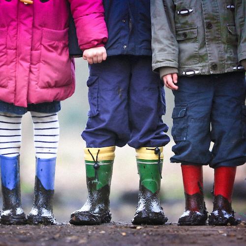 Three children stand next to each other.